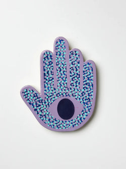 Looking for the perfect accent for your wall? Look no further than the Signal Lavender Hand by Jones & Co.   Handmade from natural Capiz shell and adorned with playful polka dots, this design features an evil eye in the centre.  *Designed for indoor use  *Length: 10cm/ Width: 13cm/ Height: 1cm  *Designed in Sydney and hand-crafted in the Phillipines by Jones & Co artisans