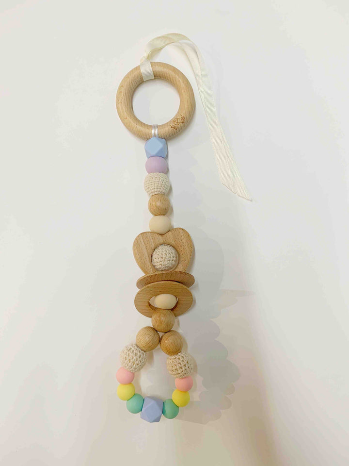 Ease your bubs teething with this Pastel Rainbow Love Teething Rattle Toy!  Designed by Lluie in Melbourne, Australia; the Love Teething Rattle Toy encourages little ones to explore important milestones through tummy time or whilst lying on their backs.